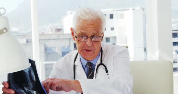 Male doctor examining x-ray