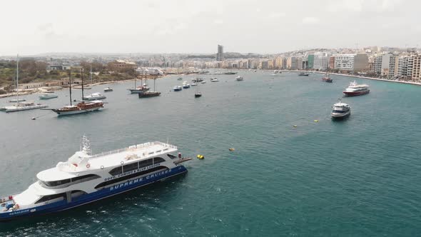 4k drone footage of a ship and boat filled harbor of the Mediterranean tourist resort town of Sliema