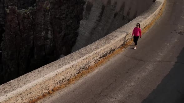 Aerial of a woman hiking across the Salmon Falls Dam in Southern Idaho