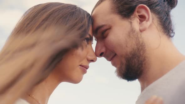 Young Romantic Couple Touching Foreheads While Looking Each Other's Eye. - Low Angle shot