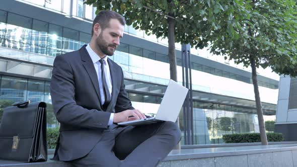 Businessman Shocked By Results While Working on Laptop