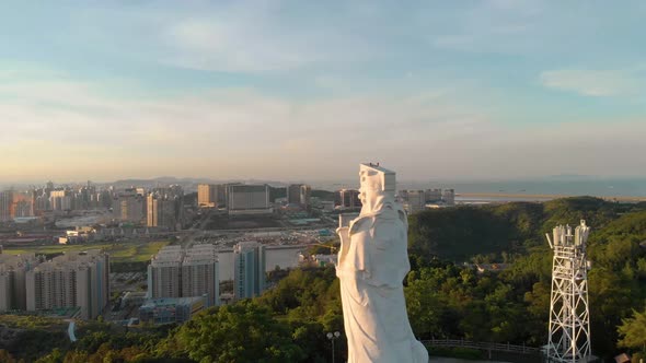 Rotating aerial revealing stunning scenery of Coloane, Macau behind Goddess A-Ma statue