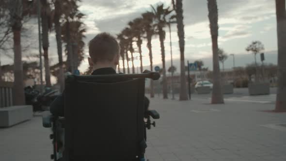 Handicapped child spinning in electric wheelchair