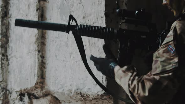 British Ranger Loading the Magazine to M16 Automatic Rifle with Suppressor Silencer