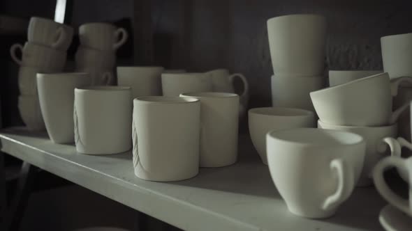 White Ceramic Mugs are on the Shelves in the Production Shop