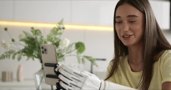 Girl Blogger with Bionic Arm Using Phone Live Streaming Social Media at Home Woman with Disability