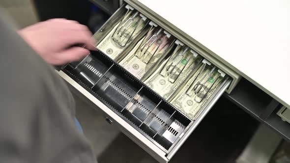 Top view of the opening department with dollars in cash at the store checkout