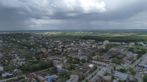 Aerial view of ruined church near the factory in city with private low houses