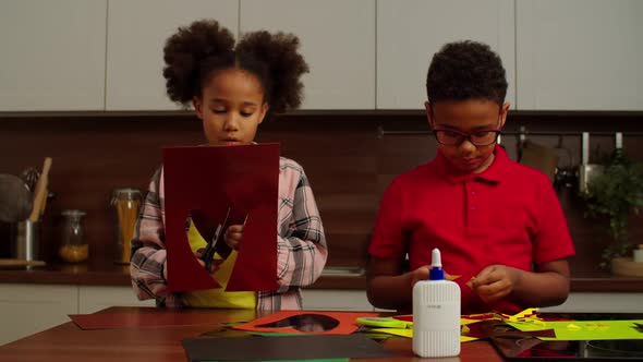 Engrossed Cute School Age Black Children Making Handmade Gift From Colored Paper