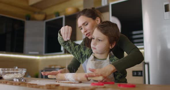 Happy Mother and Son Cooking Cookies Together in the Kitchen