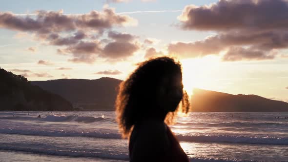 Silhouette of woman on the beach at sunset