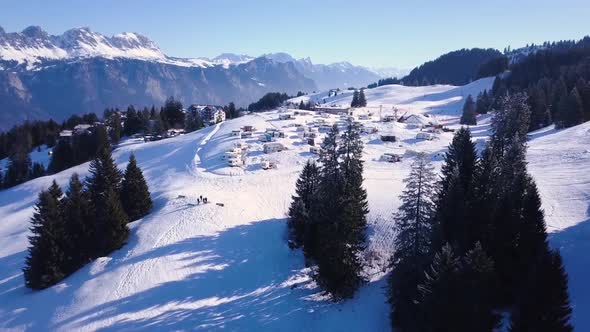 Drone shot over a trailerpark covered in snow.