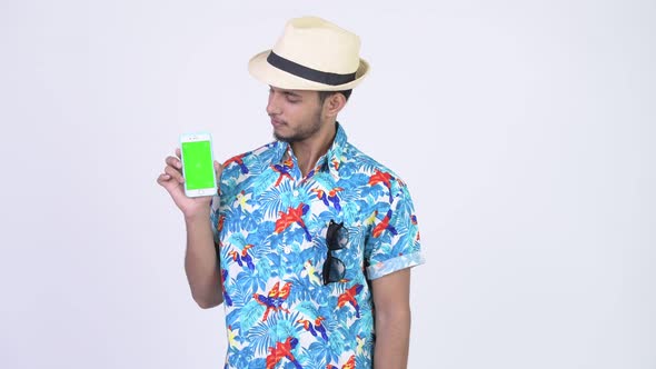 Young Happy Bearded Indian Tourist Man Showing Phone and Giving Thumbs Up