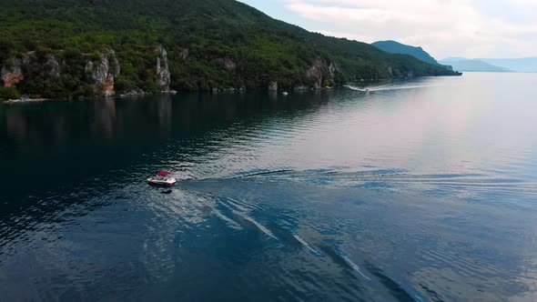 Aerial shot of Macedonia coast. Clif and beautiful water around Ohrid Lake in Southern Europe. Boat