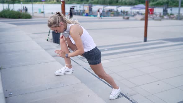 Female Jogger Lunging on Steps