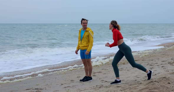 Happy Couple Doing Sports Training By the Sea