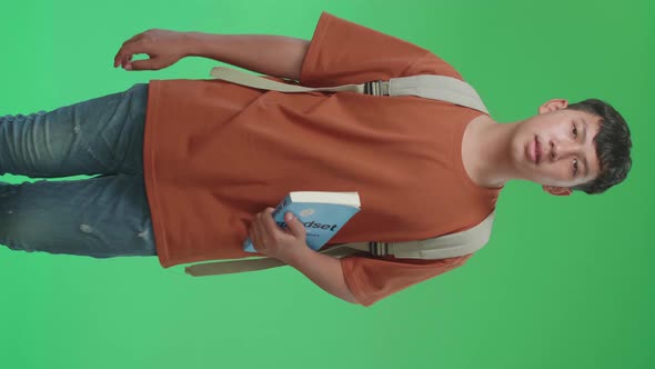 The Front View Of Asian Boy Student Holding A Book And Walking To School On Green Screen