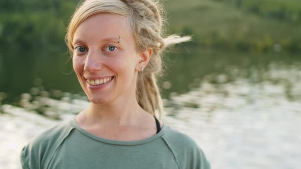 Portrait of Cheerful Blonde Woman on Lake