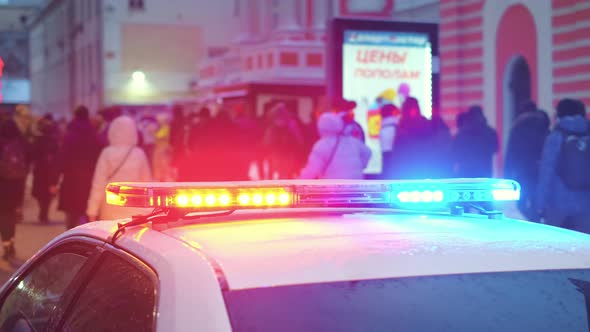 Police Enforcers Car with Strobe Flashing Lights Patrols Political Rally March