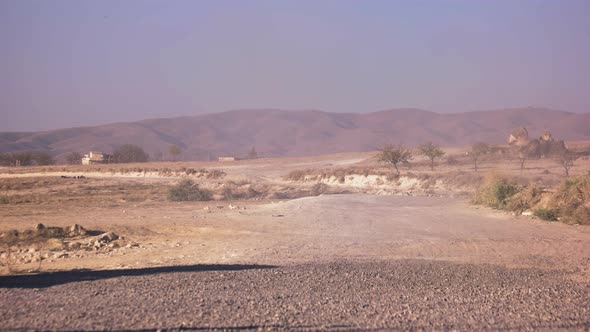 Dry Dusty Road with Mountains on the Background.