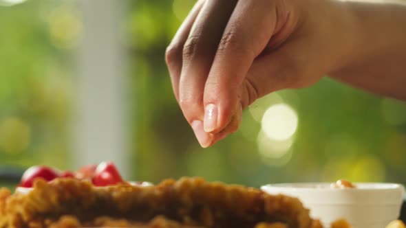 Pouring Spice Red Pepper on Fried Meat