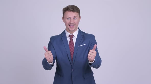 Indecisive Bearded Businessman Giving Thumbs Up and Thumbs Down