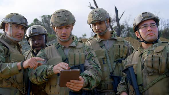 Front view of military soldiers using digital tablet during training 4k