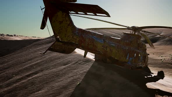 Old Rusted Military Helicopter in the Desert at Sunset alt