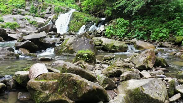 Mountain River Waterfall Flowing Between Rocky Shores in Carpathians Mountains Ukraine