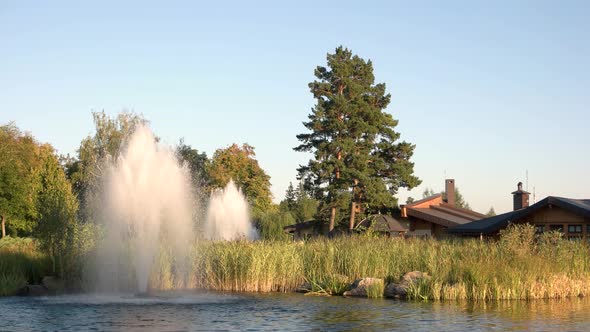 Pond with Fountains and Houses.