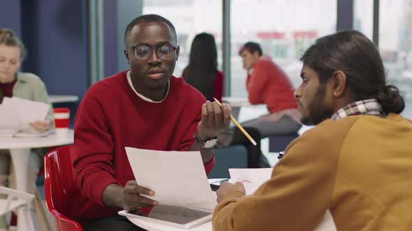 Businesspeople Discussing Work in Office Cafeteria