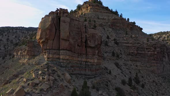 Flying up along ridge of rock desert terrain in Nine Mile Canyon