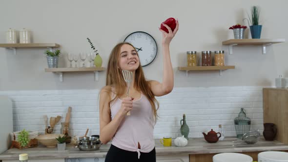 Happy Vegan Girl with Slim Waist Dancing, Singing in Kitchen. Raw Vegetable Nutrition Diet Concept