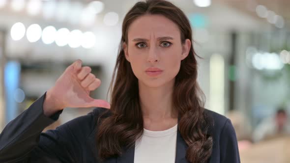 Portrait of Businesswoman with Thumbs Down Gesture 