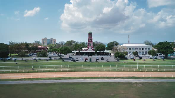 Drone camera receding from the red chapel at Garrison Savannah racecourse in Bridgetown, Barbados