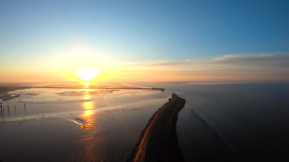 From the sky to the ground by the ocean at the sunrise drone aerial footage birds eye view