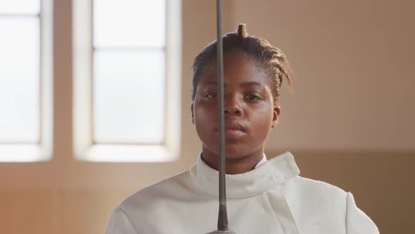 Female fencer athlete during a fencing training in a gym