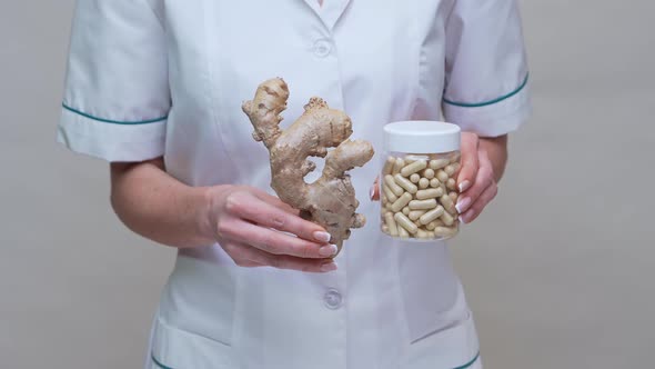 Nutritionist Doctor Healthy Lifestyle Concept - Holding Ginger Root and Jar of or Vitamine Pills