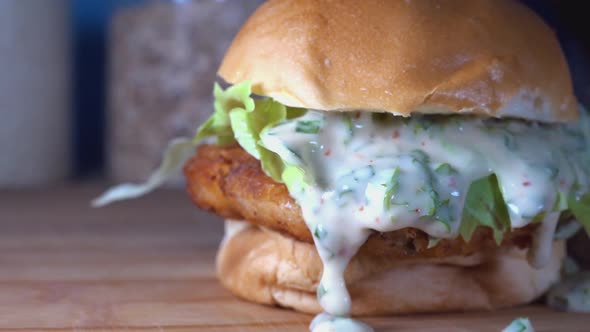 Medium Slow Motion Shot of Fish Cake Sliders with Dripping Sauce