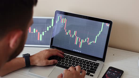 Young Adult Man Trading on Line with Tablet Pc Connected to Stock Market