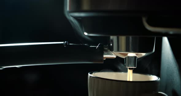 Pouring Coffee Stream From Machine in Cup