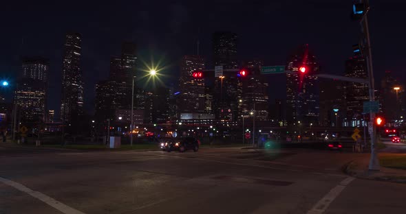 Time lapse of cars at night in Houston wit downtown in the foreground.