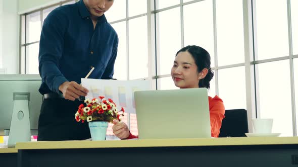 Two Business People Talk Project Strategy at Office