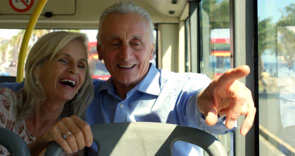 Senior couple interacting with each other while travelling in bus 4k