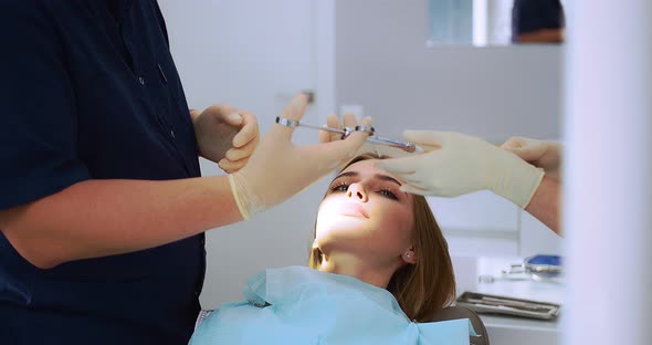 Dentist Gives an Analgesic Injection Into the Tooth of a Beautiful Woman