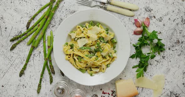 Homemade Tagliatelle Pasta with Creamy Ricotta Cheese Sauce and Asparagus Served White Ceramic Plate