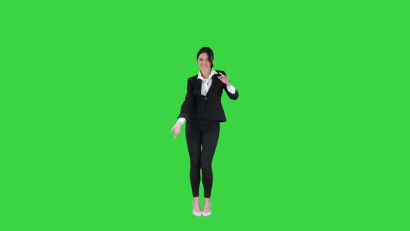 Beautiful Businesswoman Inviting You To Dance with Her on a Green Screen, Chroma Key