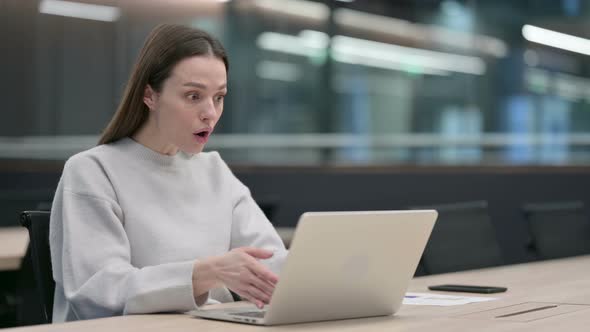 Woman Feeling Shocked while using Laptop