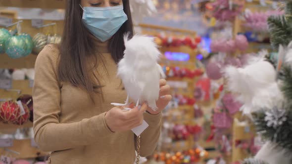 Lady Looks at Fluffy Bird Effigy and Puts on Green Pine Tree