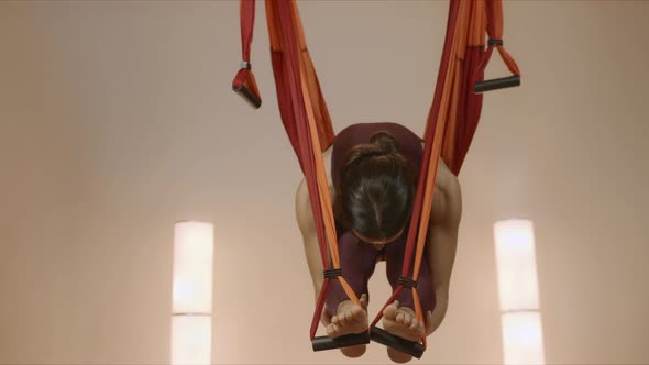 Girl Practicing Antigravity Yoga at Studio. Lady Stretching Body in Hammock